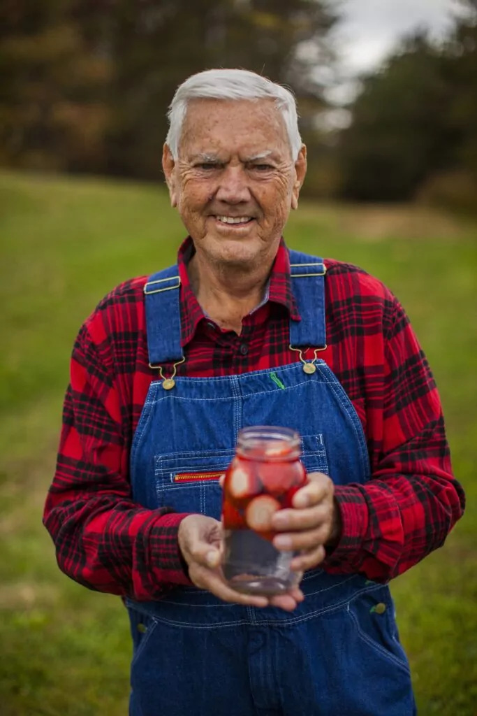 Junior Johnson shows off his Midnight Moon moonshine in a mason jar.