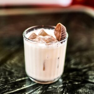 Peanut butter and cookies & cream cocktail garnished with a peanut butter cup. 