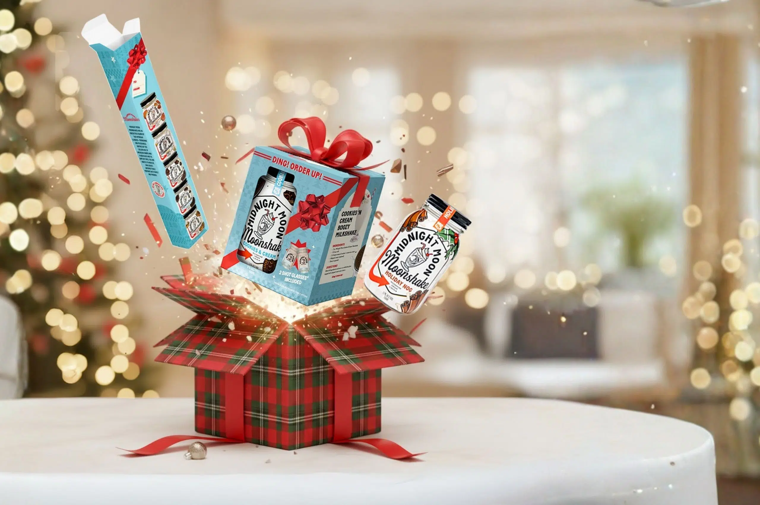 A gift box exploding with Midnight Moon Holiday Moonshake products